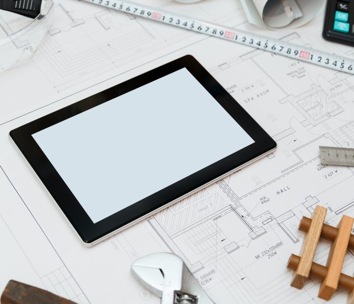 Construction plans with Tablet, drawings and tools.